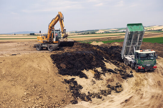 Vienna, Austria - 05.05.2019:ROGNER truck and LIEBHERR excavator.Laying new expressways in Austria.Excavator on the road construction works. Machinery needed for construction.

