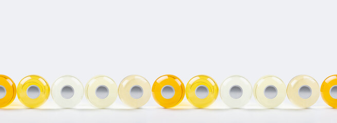 Collection lying bottles with different pale colors liquid or cosmetic product and blank silver cap...