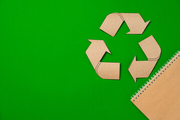 Paper recycling concept on green background top view