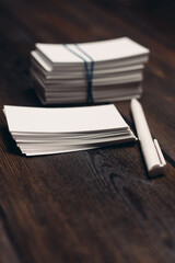 stack of white business cards and pen on office desk wooden background