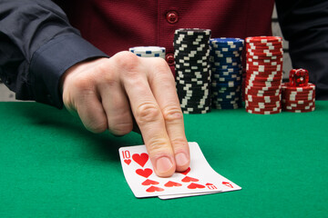 two blackjack playing cards on the green baize table in the casino