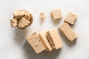 Turkish sweet dessert halva prepared from peanut on a white background.