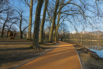 Early morning lights of dawn on the alleys of the park. Parc de la Tete d'Or is one of the larger city park in France