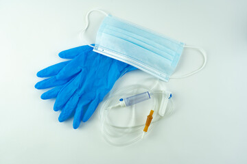 Medical mask, gloves and dropper on a white background.