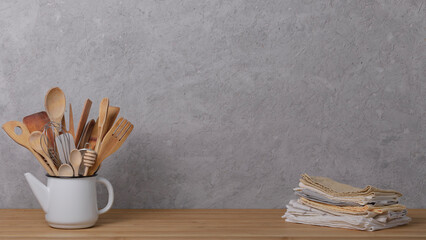 Kitchen tools, utensils and kitchenware on the table on a grey concrete background. Selective focus.