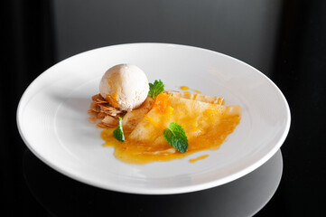 French crepe with fresh sweet orange sauce and ice cream. Top view