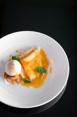 French crepe with fresh sweet orange sauce and ice cream. Top view