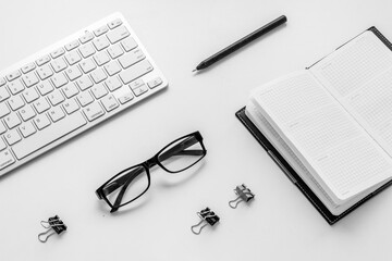 Office workplace flat lay with keyboard wand notebook