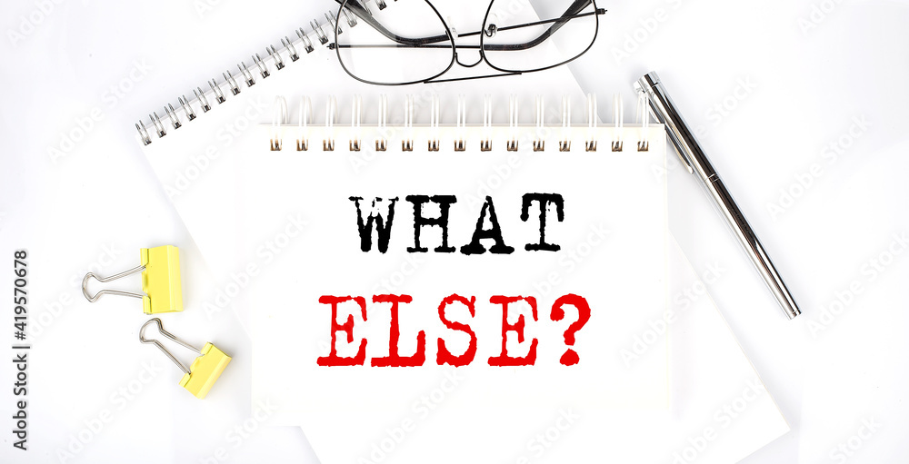 Poster what else text on the notebook with pen,clips and glasses