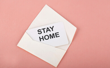 Word Writing Text STAY HOME on card on the pink background