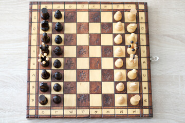 beige and brown wooden chess figures and chessboard 
