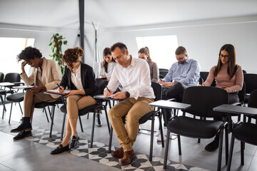 People taking test on a business seminar.