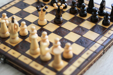 beige and brown wooden chess figures and chessboard 
