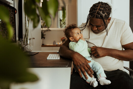 Black father and daughter together at home.