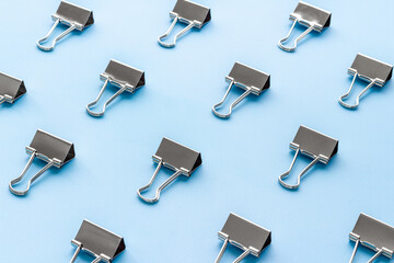 Paper binder clips. Stationery and office supplies background.