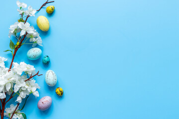 Happy Easter with eggs and flowering branch, top view