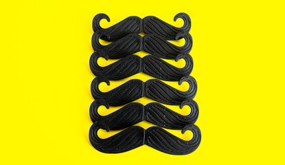 Composition of mustache. Father's day holiday concept. Mustache on a yellow background. No shave...
