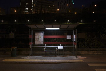 Bus stop in the street at night