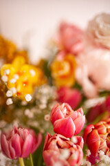 Bright spring flowers. The prism effect. Tulips, peony roses,  silver acacia, mimosa, daffodil, gypsophila. Selective focus. Bright background for your desktop.