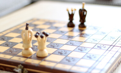 beige and brown wooden chess figures and chessboard 
