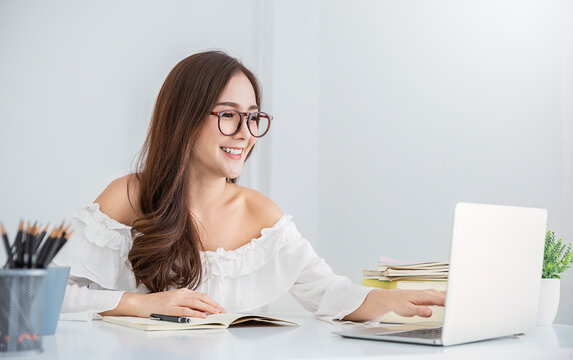 Portrait of smiling beautiful business asian woman working in office use computer with copy space. Business owner people sme freelance online marketing e-commerce telemarketing, work from home concept