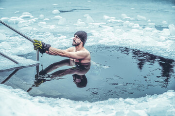 Winter swimming. Man in an ice-hole.