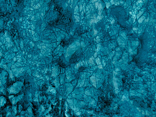 Rough textured light turquoise cosmic blue matte abstract stone with cracks and relief background. Wall. Ice, top view