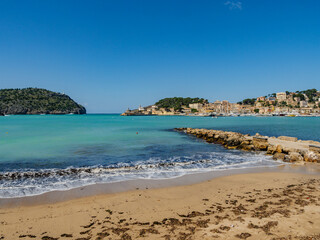 Fototapeta na wymiar beach with trees in the village of Port de Soller on the balearic island of Mallorca, spain
