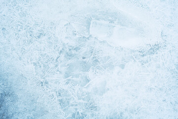 Texture of ice on the frozen lake. Blue color background.