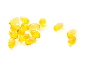 Shiny yellow fish oil capsules isolated on a white background. Vitamin E. Copy space for your text