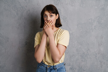 Portrait of a beautiful shocked young girl in casual clothes