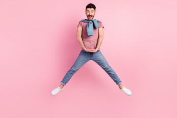 Fototapeta na wymiar Full size photo of funky funny young man jump up good mood amazed isolated on pastel pink color background