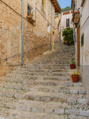 Fototapeta na wymiar narrow street with stairs in the town of Banyolas on the balearic island of Mallorca, spain