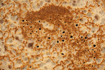 Pancake texture. Close-up of thin hot pancakes in a plate. Traditional rustic food. Folk cuisine. Table top view. Maslenitsa food.