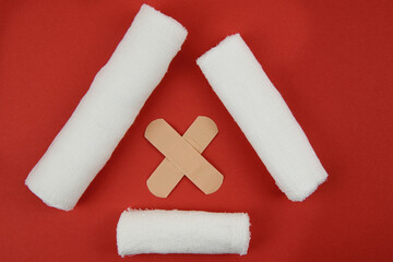 Cross made of bandages and triangle made of bandages composition