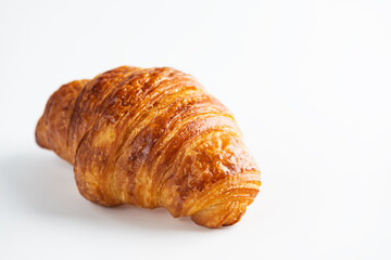 Fresh French croissant on a white background.