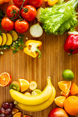 Fruits and vegetables on wood desk. Vertical photo with place for text.