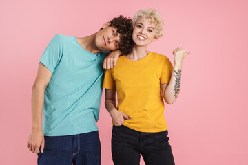 Cheerful young teenage couple poointing
