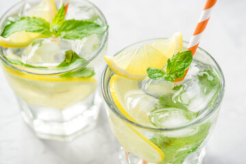 Cold refreshing lemonade or mojito with ice and mint leaves.