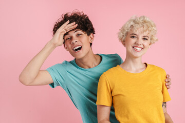 Happy young couple of teenagers standing isolated