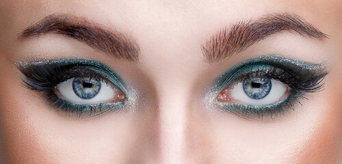 Close-up view of the eyes of a young girl with beautiful makeup