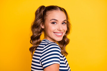 Profile side view portrait of attractive cheerful girl wearing summer tshirt isolated on bright yellow color background