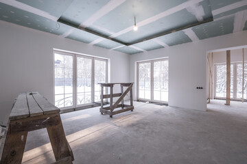 empty white room without repair and furniture with scaffolding
