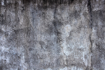 Aged concrete wall with wet stain. Faded grey asphalt closeup. Cracked concrete surface top view. Old building wall abstraction. Natural material background for shabby design. Concrete wall texture
