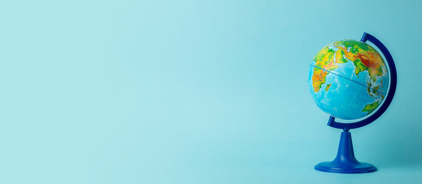 Earth globe on clean blue banner background. Education, school, study and knowledge background concept.
