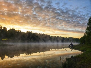 Naklejka na ściany i meble fishing on the river at dawn