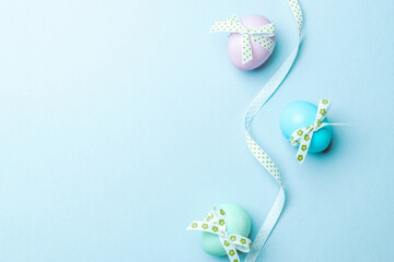 Easter set. Colorful egg with tape ribbon on pastel blue background in Happy Easter decoration. Traditional design with copy space.