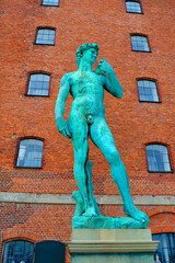 Naklejka premium David Statue on the background of the old brick building. Copenhagen, Denmark. Vertical view
