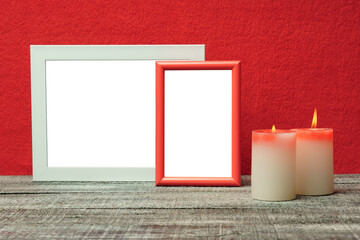 mockup of red and white frames and candles on a black table.