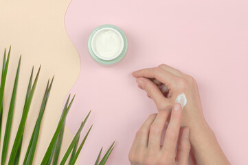 A woman applies moisturizer to hands. Organic cosmetics for skin care. Beauty concept